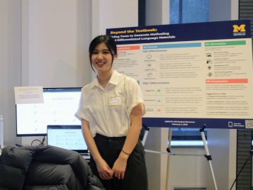 De-Ying Sun standing by a the project, "Beyond the Textbook: Using Twee as an AI Co-Creator for Generating Motivating and Differentiated Language Materials."
